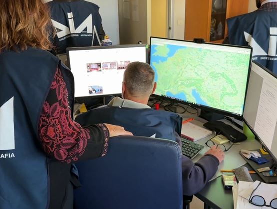 Investigators from the Italian anti-mafia directorate working at their desks