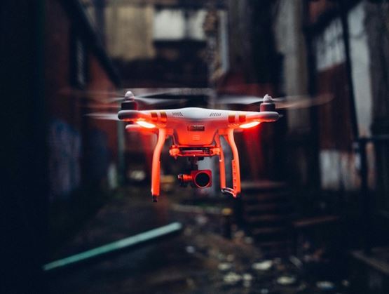 Drone flying in an urban alley at dusk
