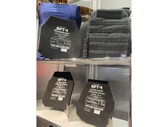 BPT display featuring Feather-Light and Ultra-Light ballistic plates on a shelf at Milipol Paris, showing different protection levels and configurations.