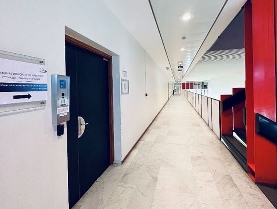 Entrance corridor at the Nanterre Judicial Court, showing the offices of the French National Unit for Serial and Unsolved Crimes (PCSNE).