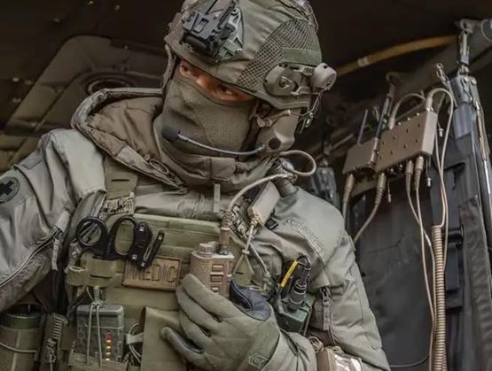 Security forces operator using a tactical radio system inside an operational vehicle