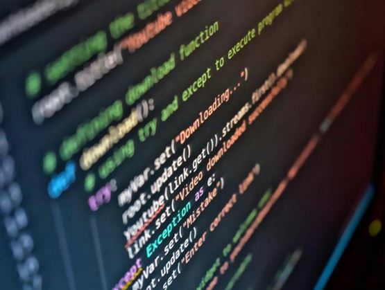 Close-up of computer code displayed on a screen illustrating digital emergency management and cybersecurity systems