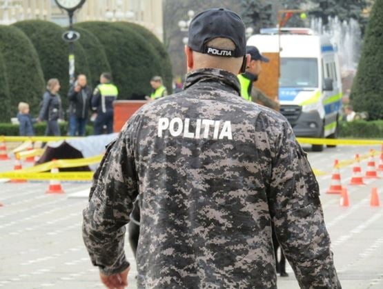 Law enforcement officer monitoring a secured public area during a police operation