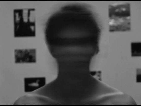 Black and white portrait of a man with a blurred face symbolising anonymity and the risks linked to digital identity