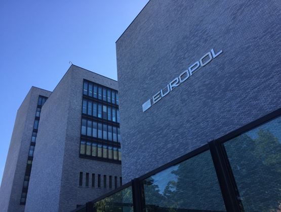 Facade of a modern brick building with the Europol logo.