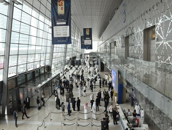Visitors and professionals gathered inside a large modern exhibition and convention venue.
