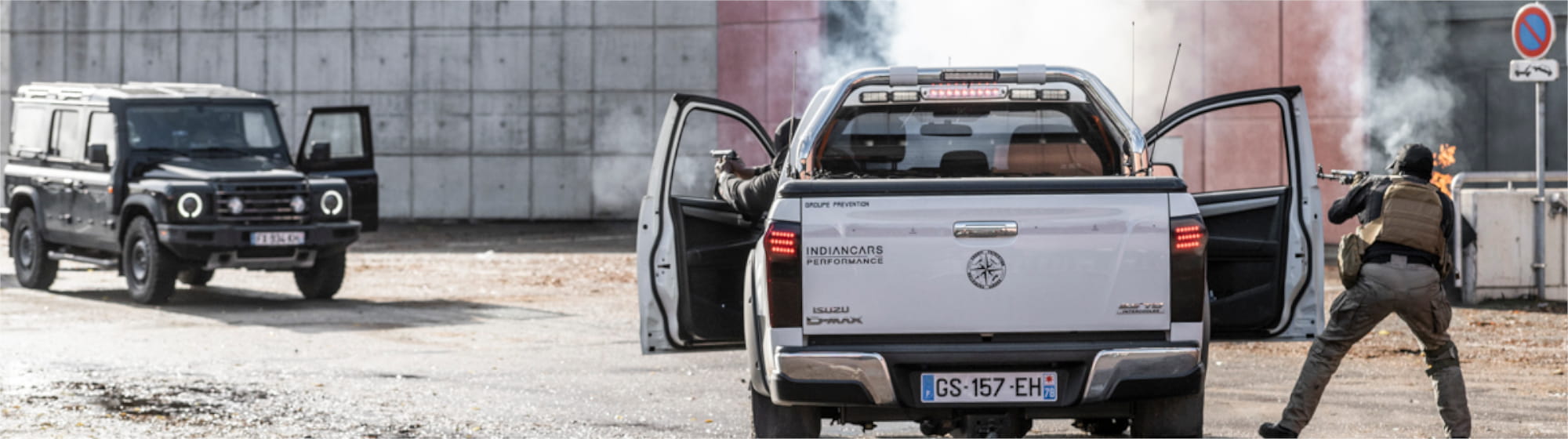 Special forces demonstration at Milipol Paris, with armed agents shooting from a white pickup truck during a simulated intervention