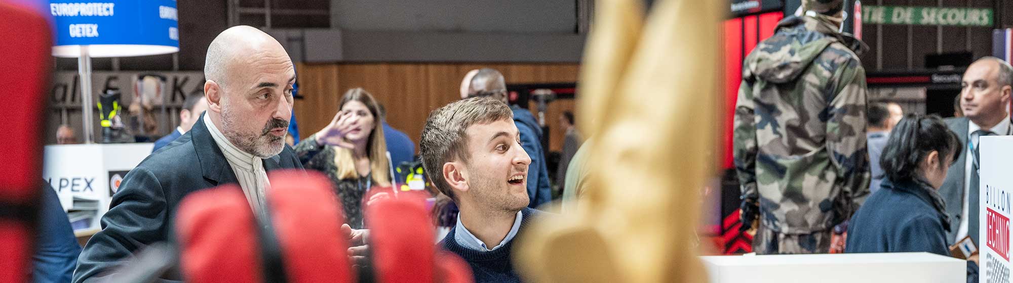 Exhibitor specialised in protective gloves smiling at someone