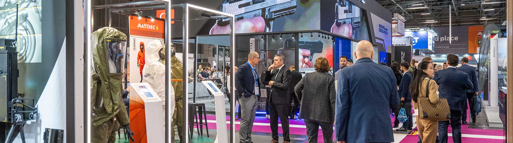 Visitors walking and discussing in front of the Sarsilmaz and Matisec stand, which is displaying dressing for first-responders