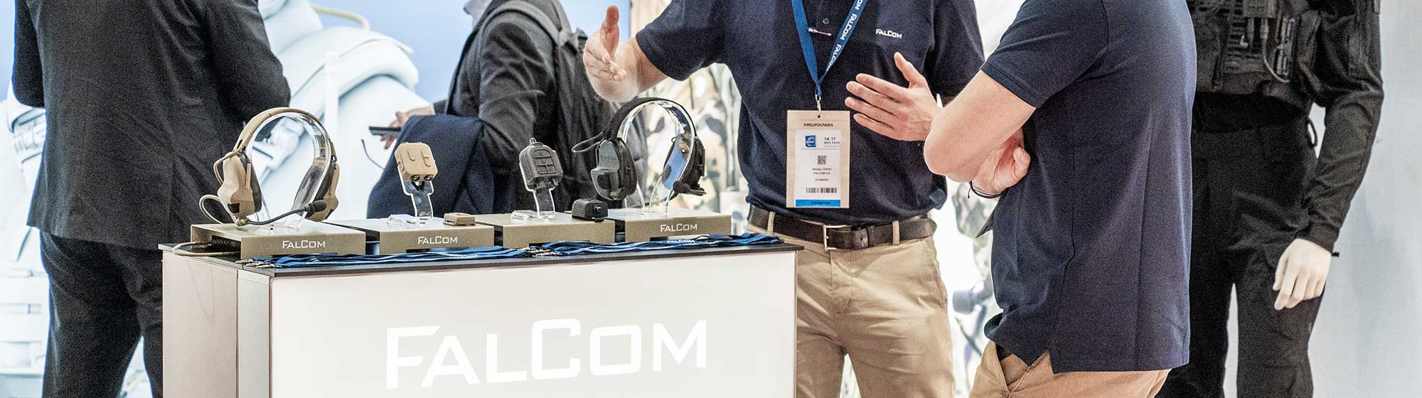 Man presenting several FalCom products and solutions to a visitor