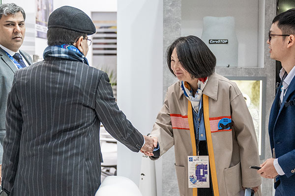 A man and a woman shaking hands on a stand