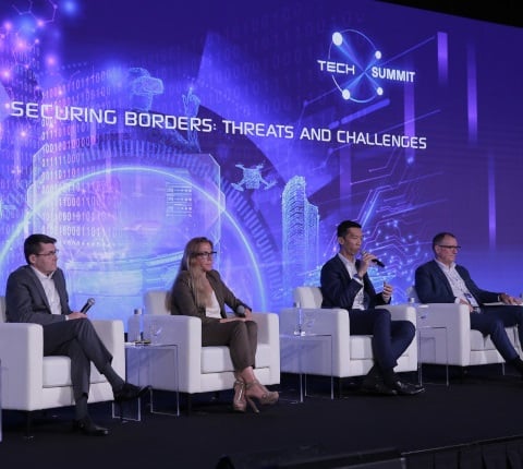 4 men seated on stage in the conference room at the Milipol Asia Pacific event