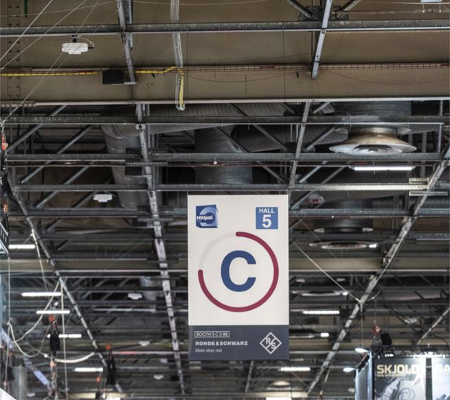 Signage with an exhibitor logo on an aisle letter at Milipol Paris.