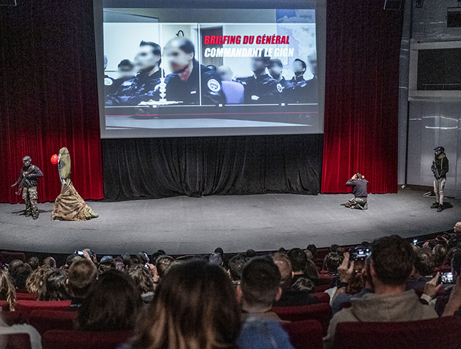 Spectators watching a GIGN demonstration in an auditorium