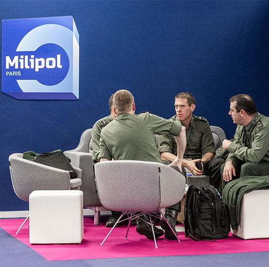 4 men in uniform discussing at a table in the VIP/DO lounge