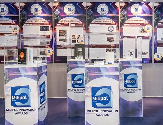 Two men consulting the finalist products during the Milipol Innovation Awards exhibition