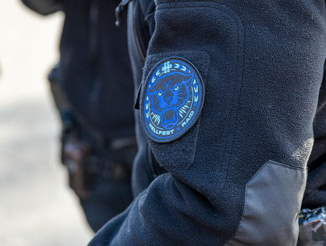 Arm of a RAID policeman with logo